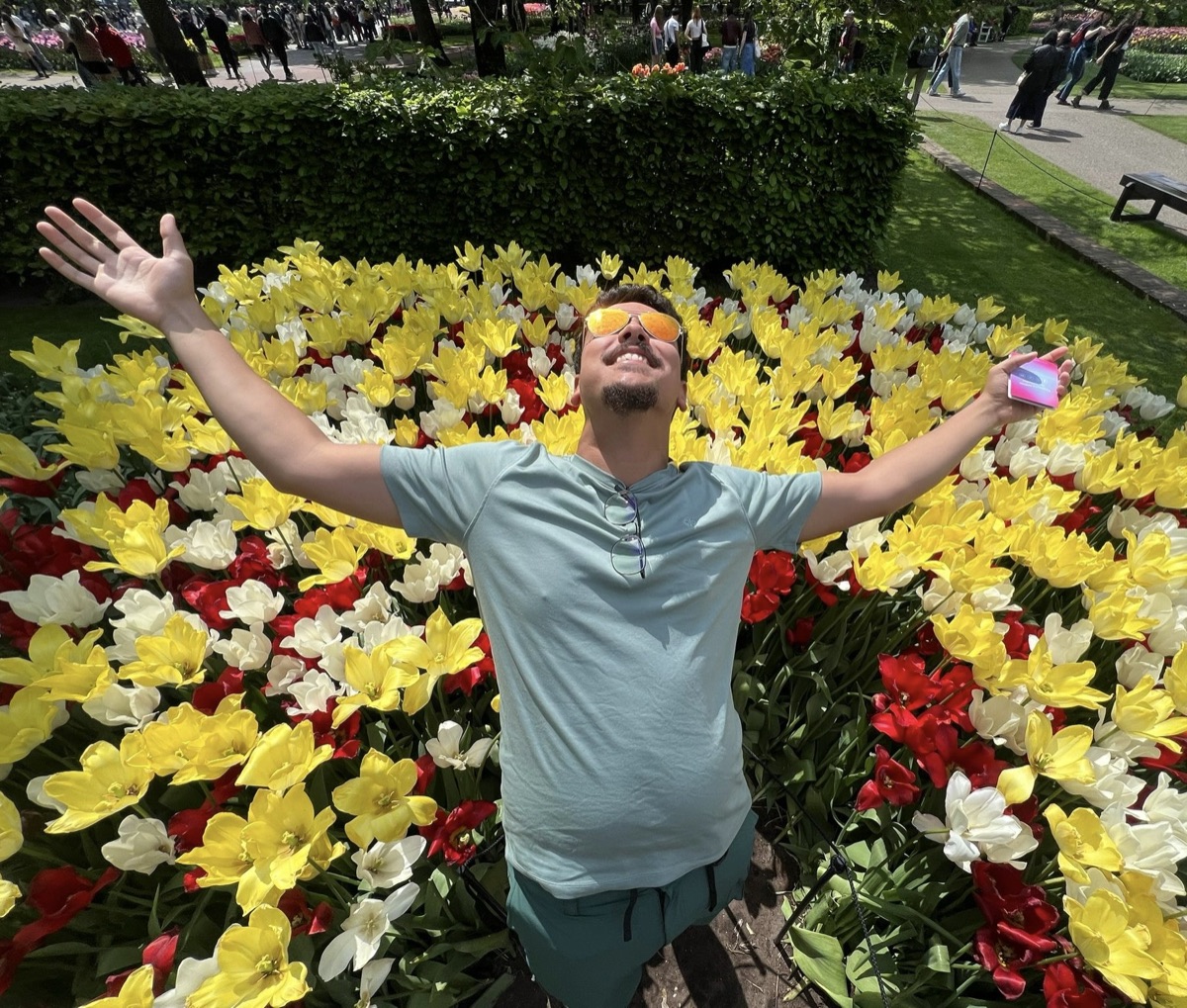 Yusuf celebrating in a field of tulips